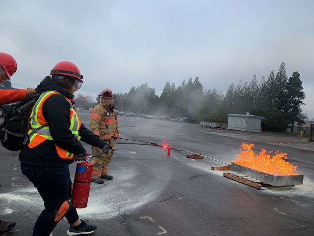 NET trainees learning to put out a fire at final field exercise