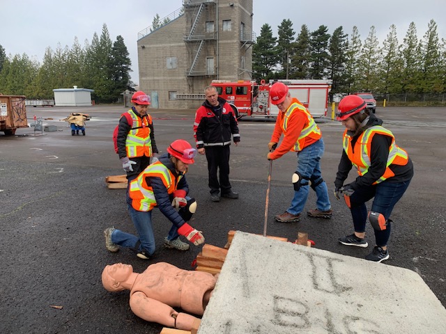 NET trainees learning out to using cribbing to extract a simulated victim from structural collapse.